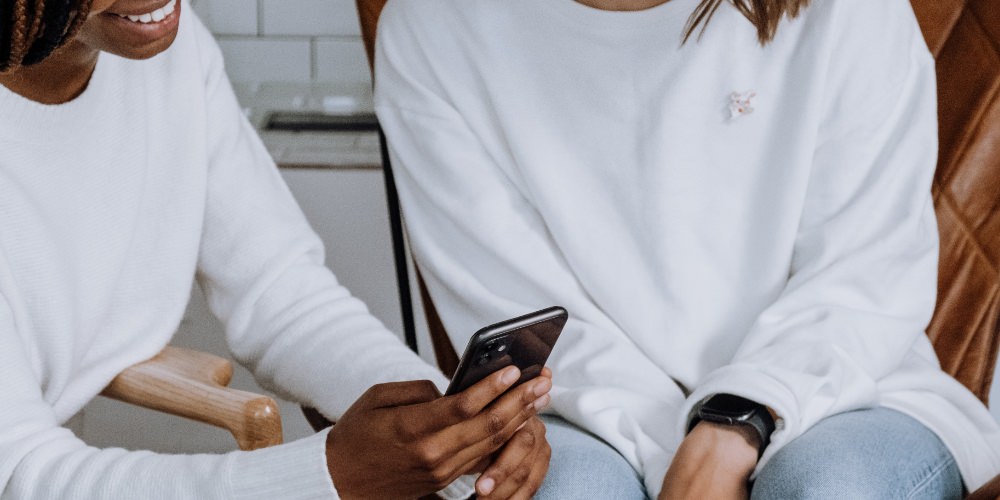 Don't buy Facebook likes - women looking at phone